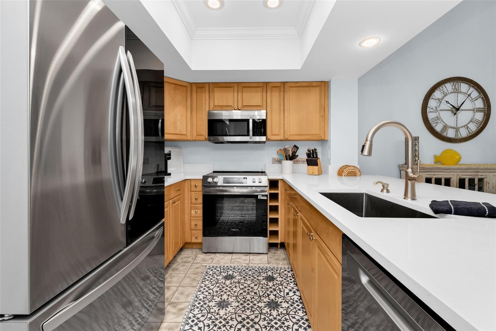 Beautiful kitchen with NEWER stainless steel appliances and quartz countertop.