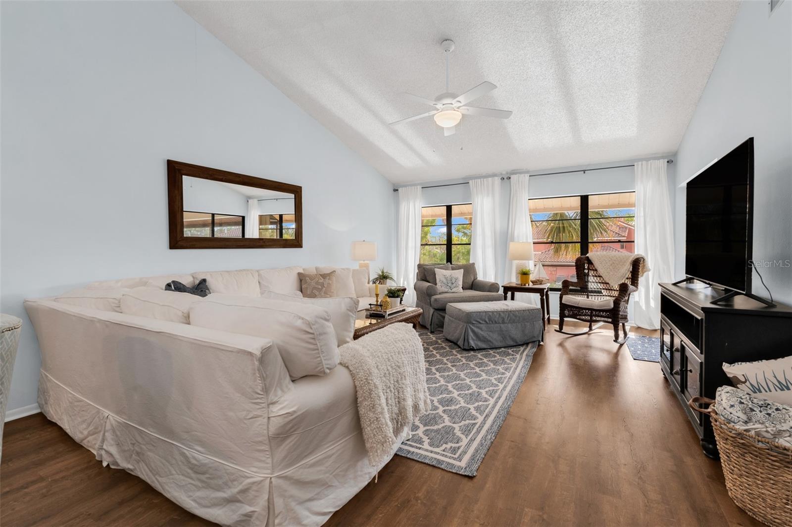 Livingroom with vaulted ceilings, completely furnish condo.