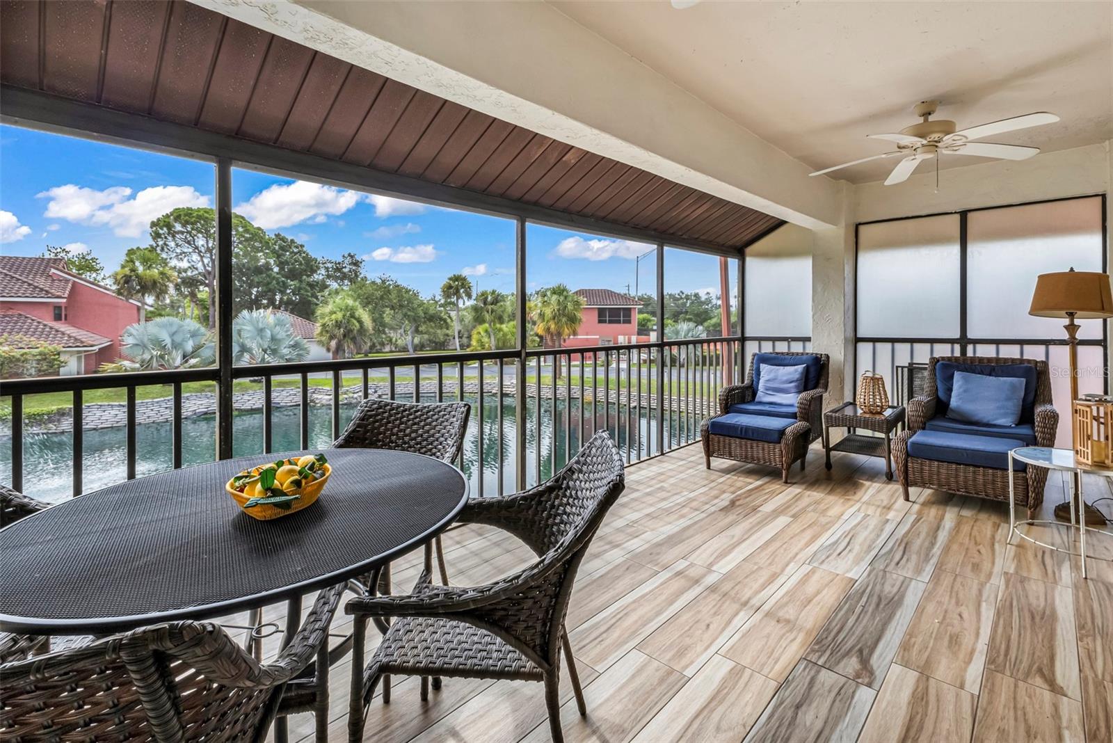 Enjoy water view from your screened in lanai with new porcelain tile flooring.