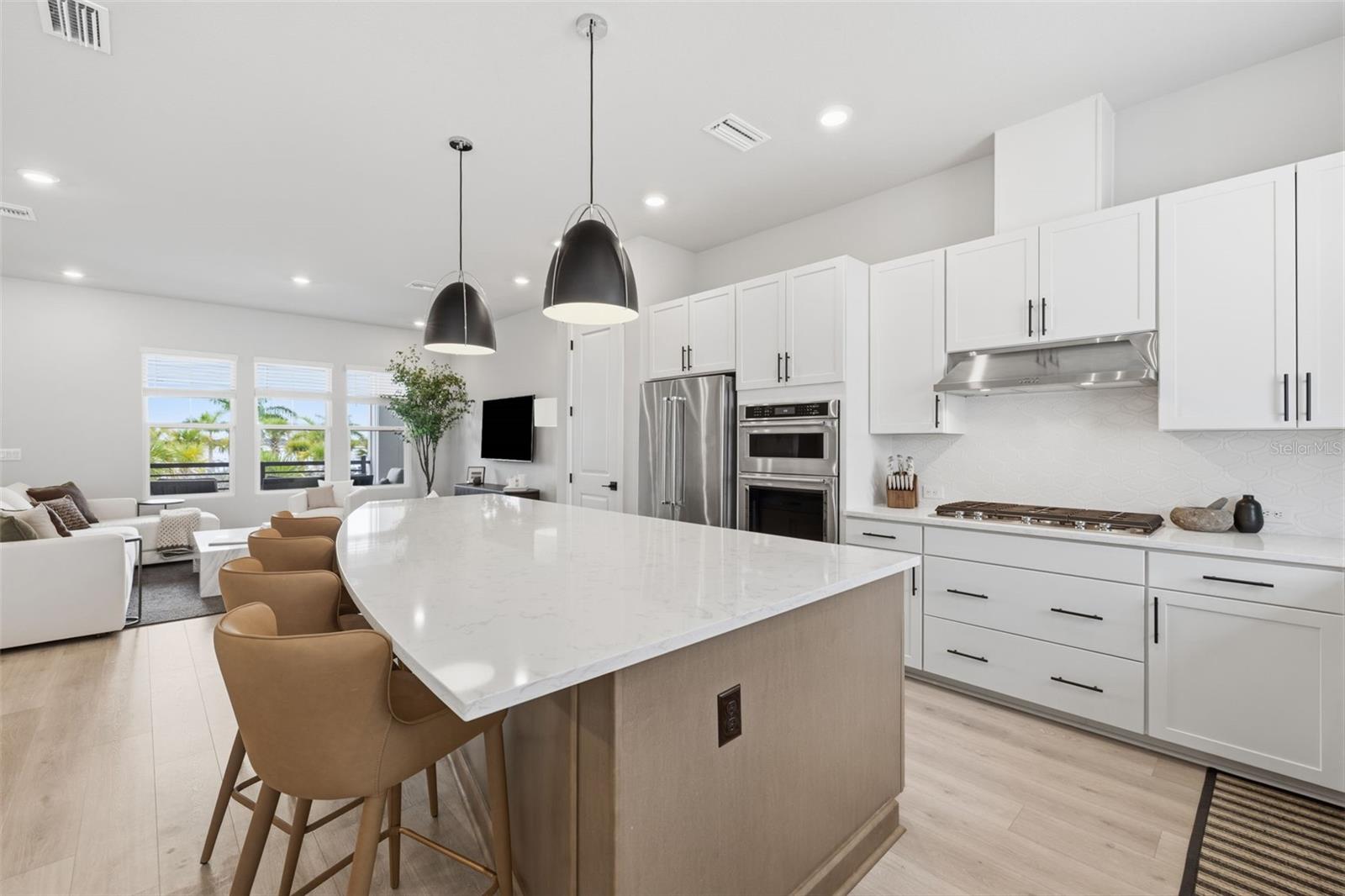 Chef's Kitchen w/ 10 ft center island, Kitchen Aid SS appliances including GAS cooktop, wine refrigerator, Quartz countertops, two-tone custom cabinetry