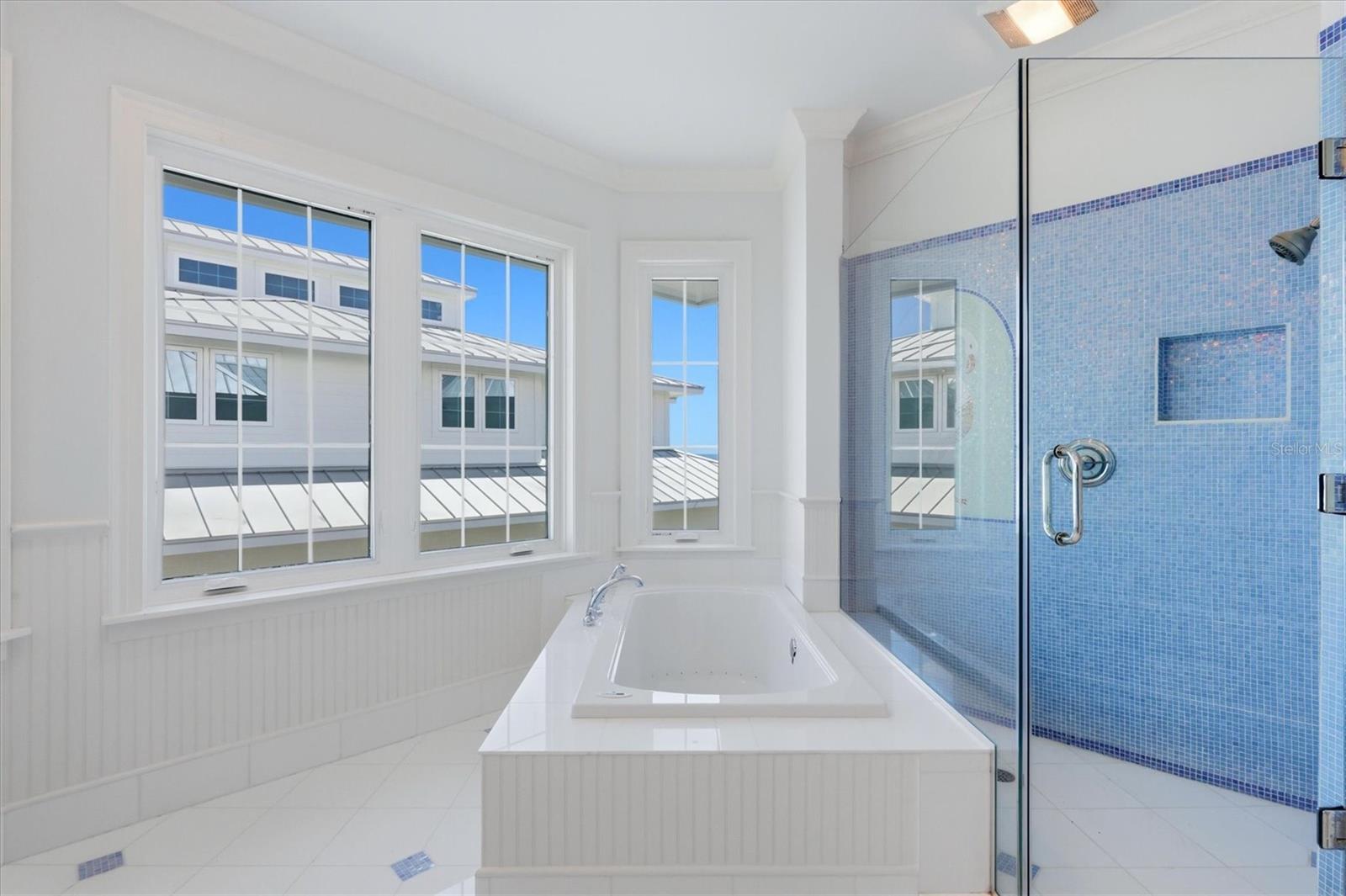 Primary bath with Gulf views and a soaking tub