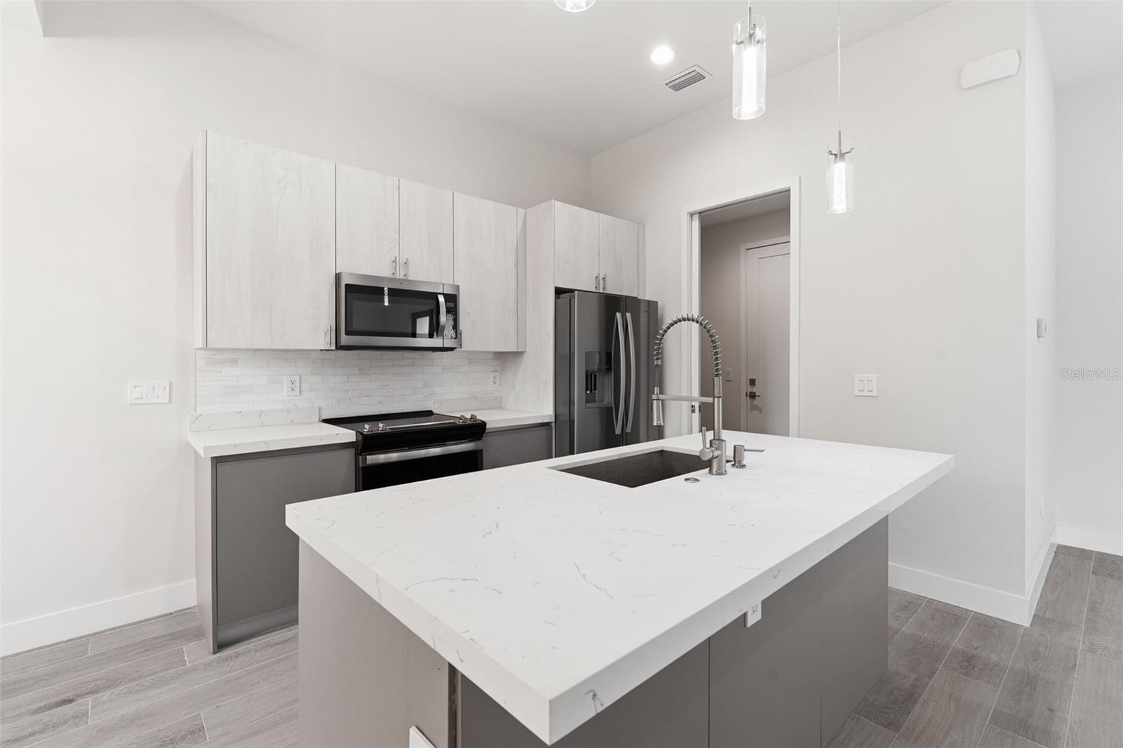 Kitchen Features Breakfast Bar and Stainless Appliances