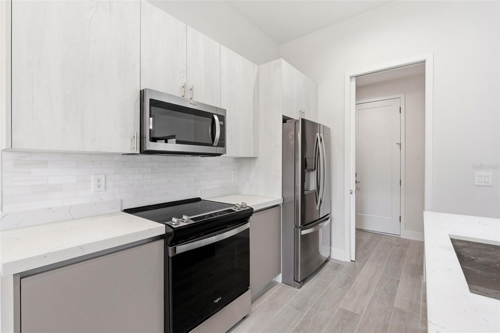 Beautiful Kitchen with European Inspired Cabinetry and Quartz Counters