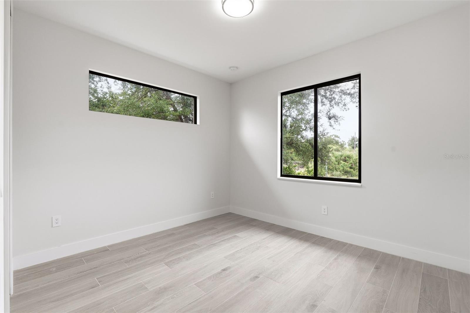 Bedroom 3 Features Porcelain Plank Tile Flooring & Clerestory Window