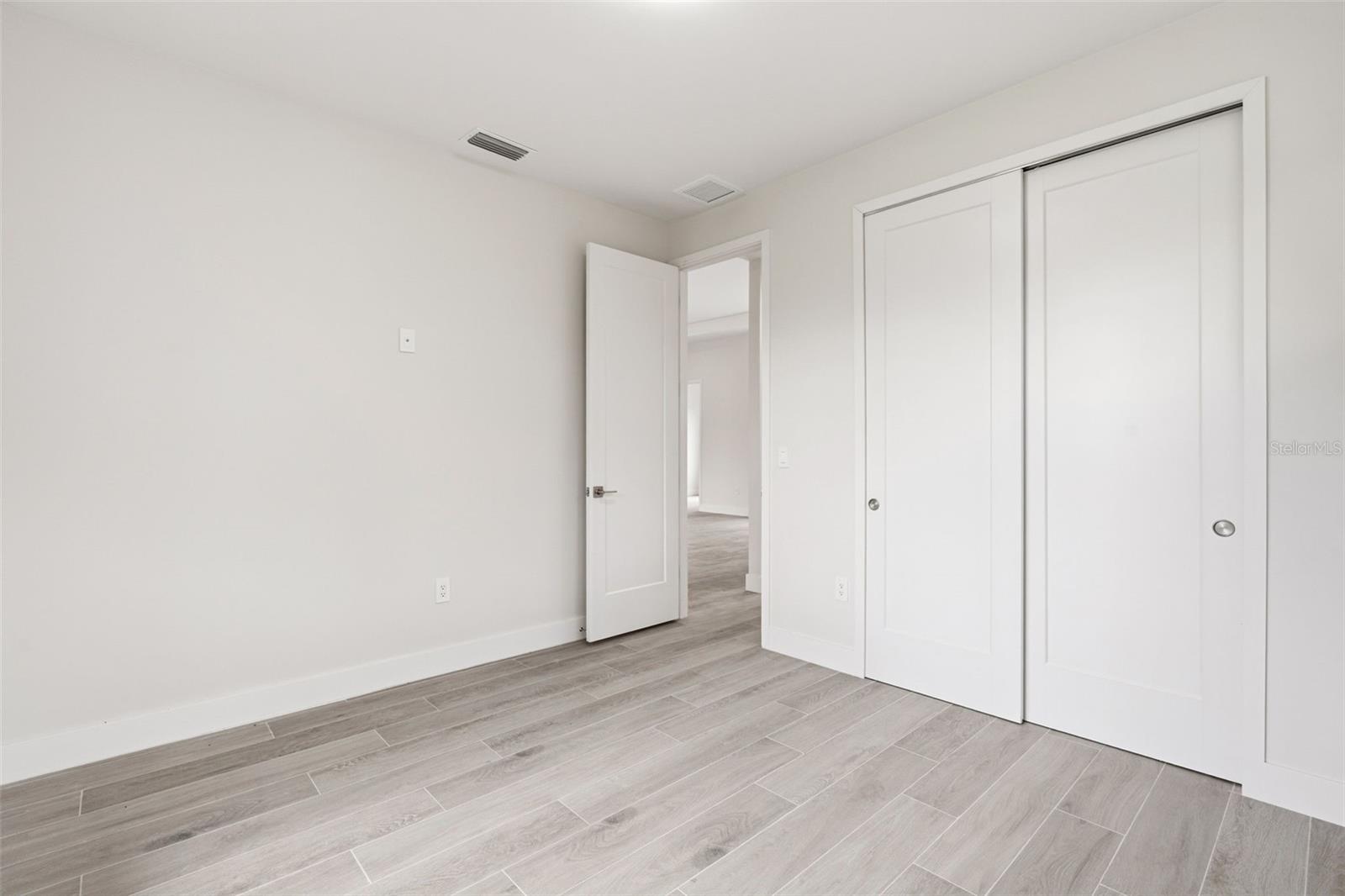 Bedroom 3 Features Porcelain Plank Tile Flooring