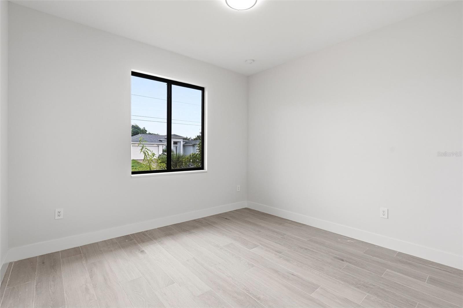 Bedroom 4 Features Natural Light & Porcelain Plank Tile Flooring