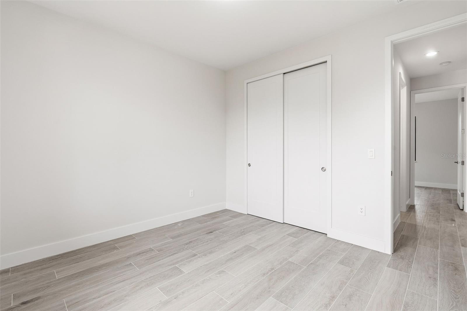 Bedroom 4 Features Natural Light & Porcelain Plank Tile Flooring