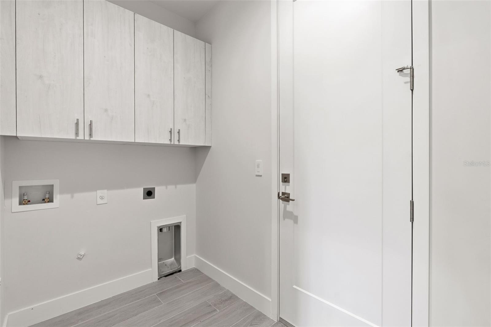 Inside Laundry Room with Extra Cabinetry