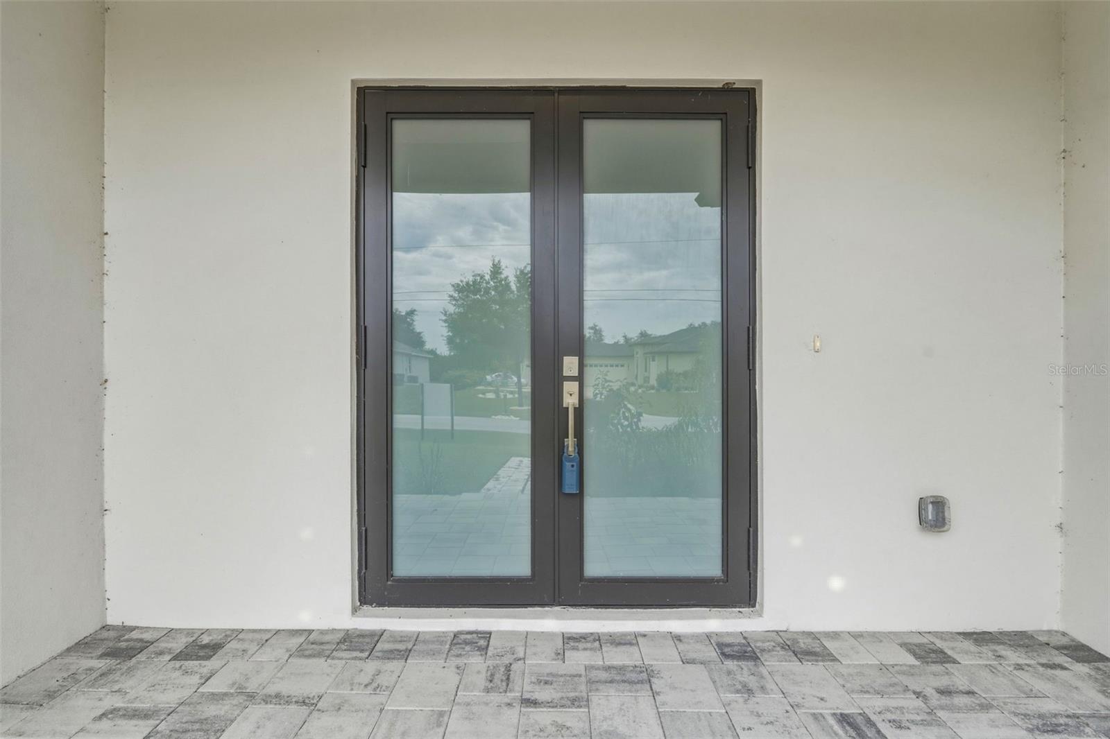 Covered Front Entry with Paver Walkway and Elegant Design