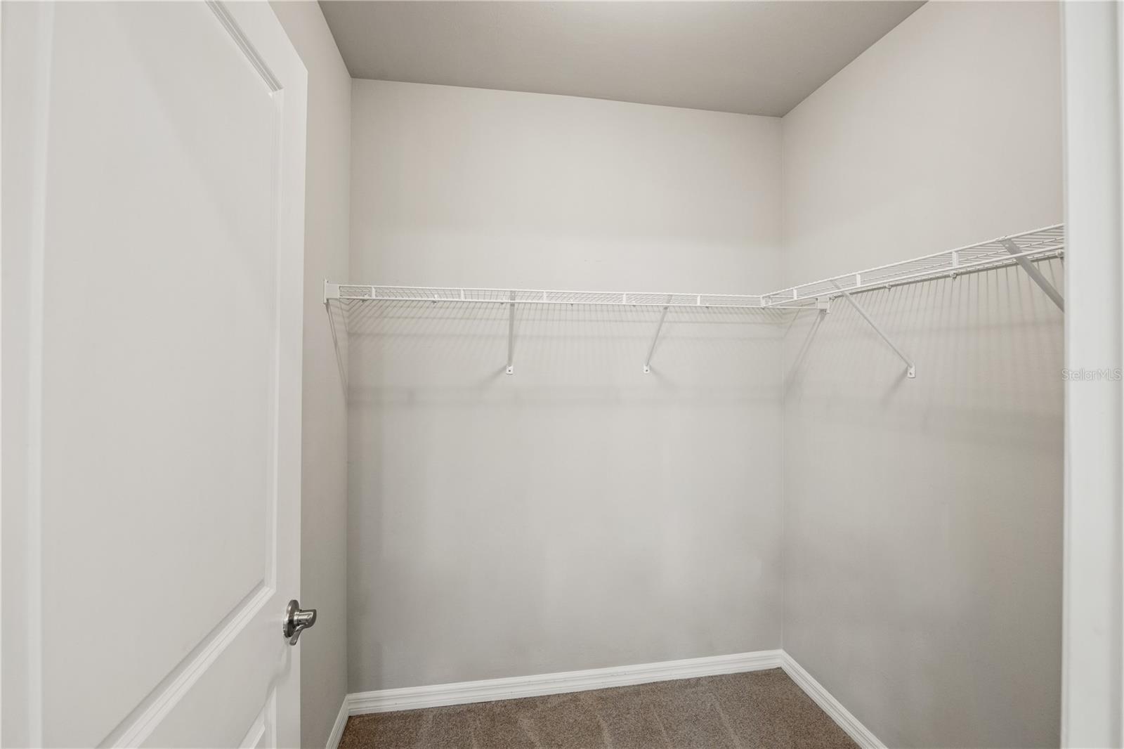 spacious walk-in closet in main bedroom suite