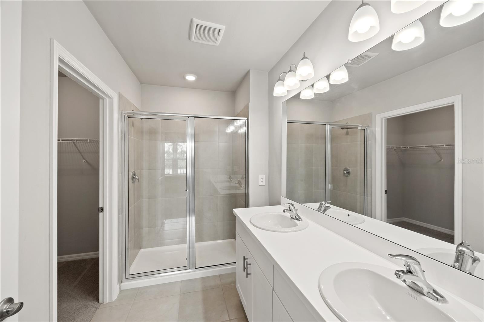 main bedroom bath with walk in shower, closet and water closet