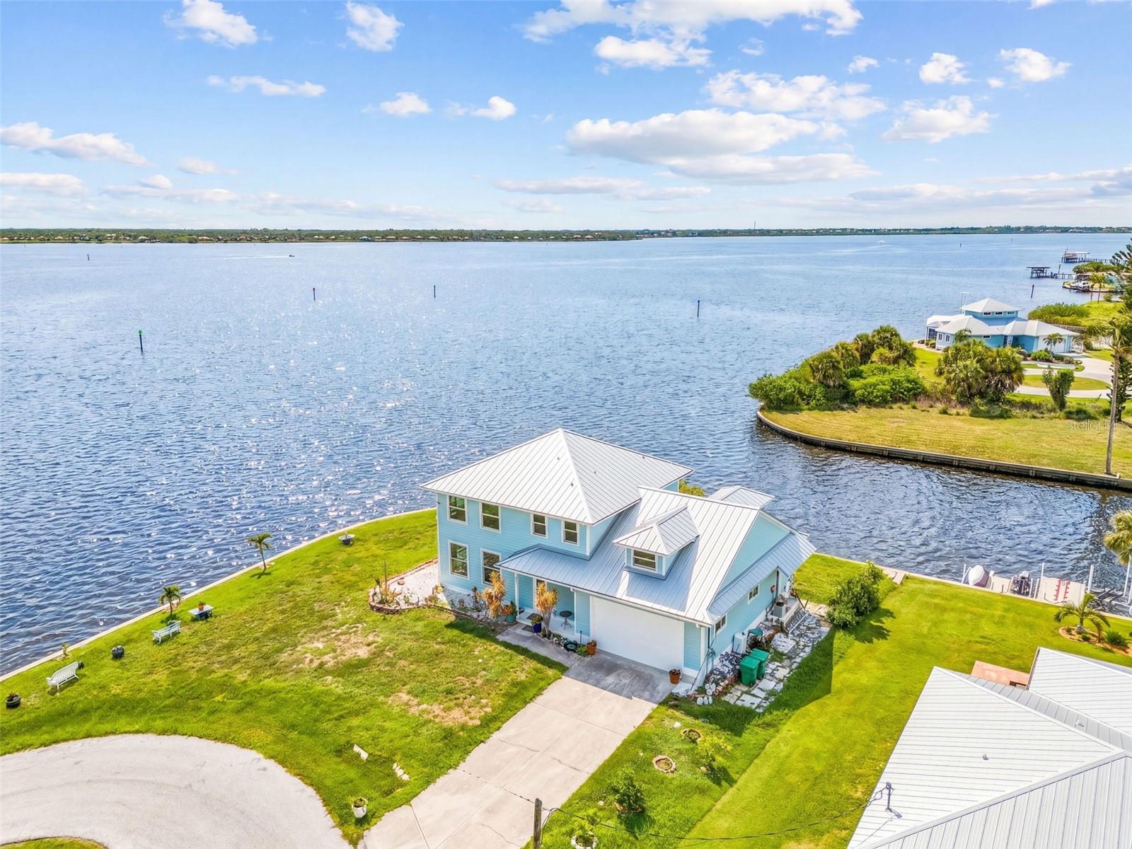 Aerial view of the home with the canal and river behind the property.