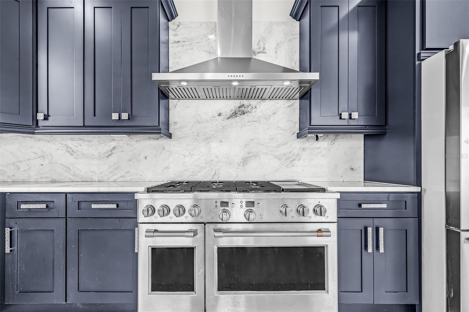 Kitchen featuring main oven with full-height backsplash