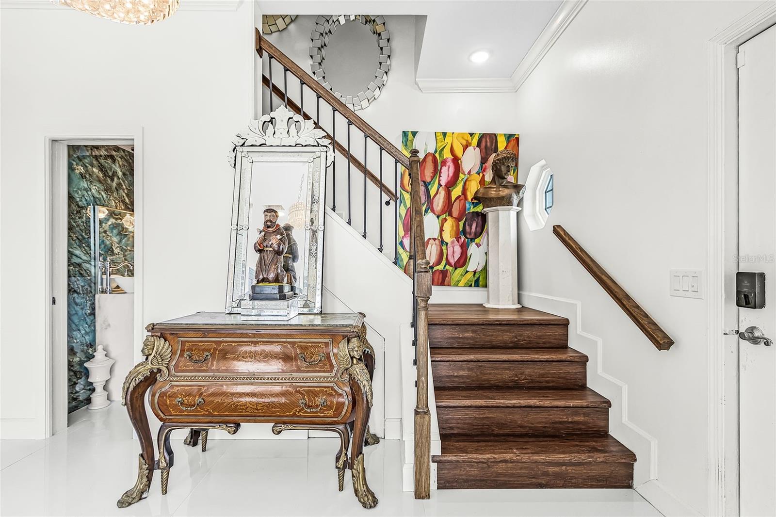 Staircase leading to the second floor with main entrance to the right