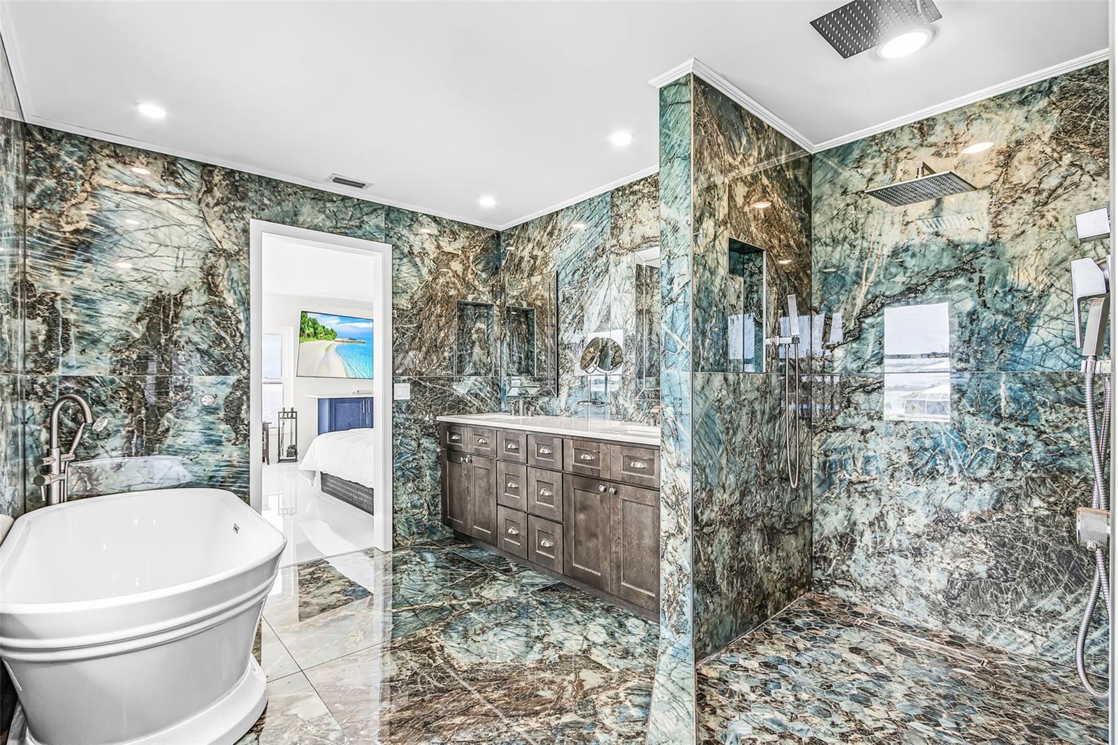 Second-floor primary bathroom featuring a walk-in shower and soaking tub