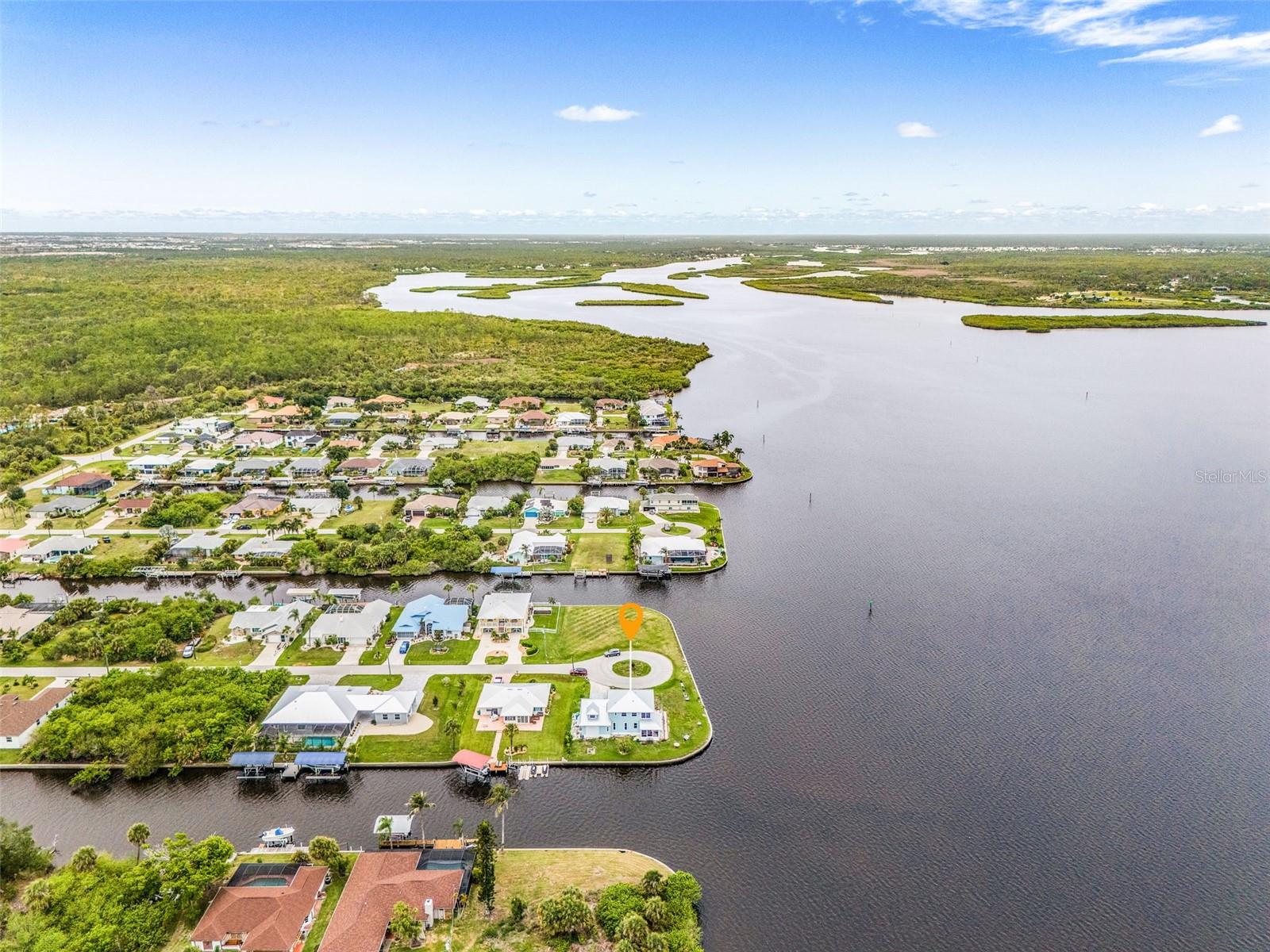 Aerial view of the west side of the home with river and canal views