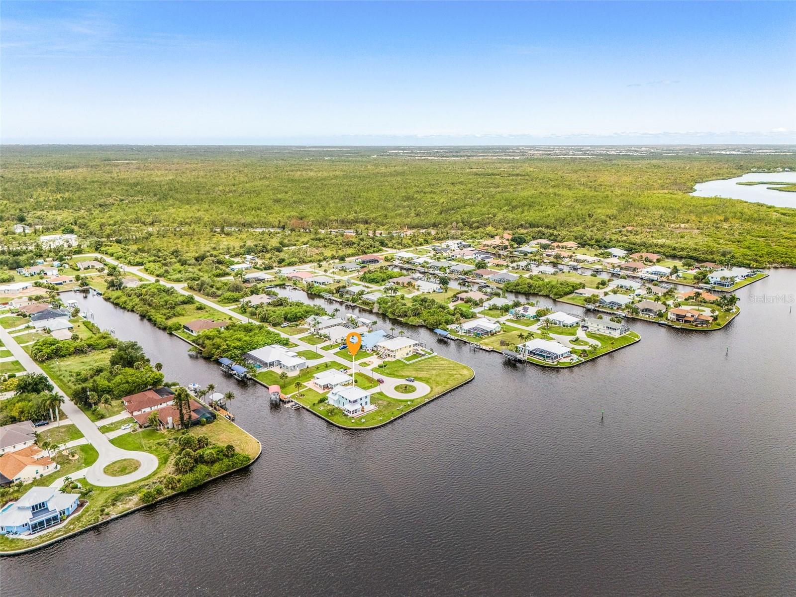 Aerial view of the south side of the home with river and canal views.