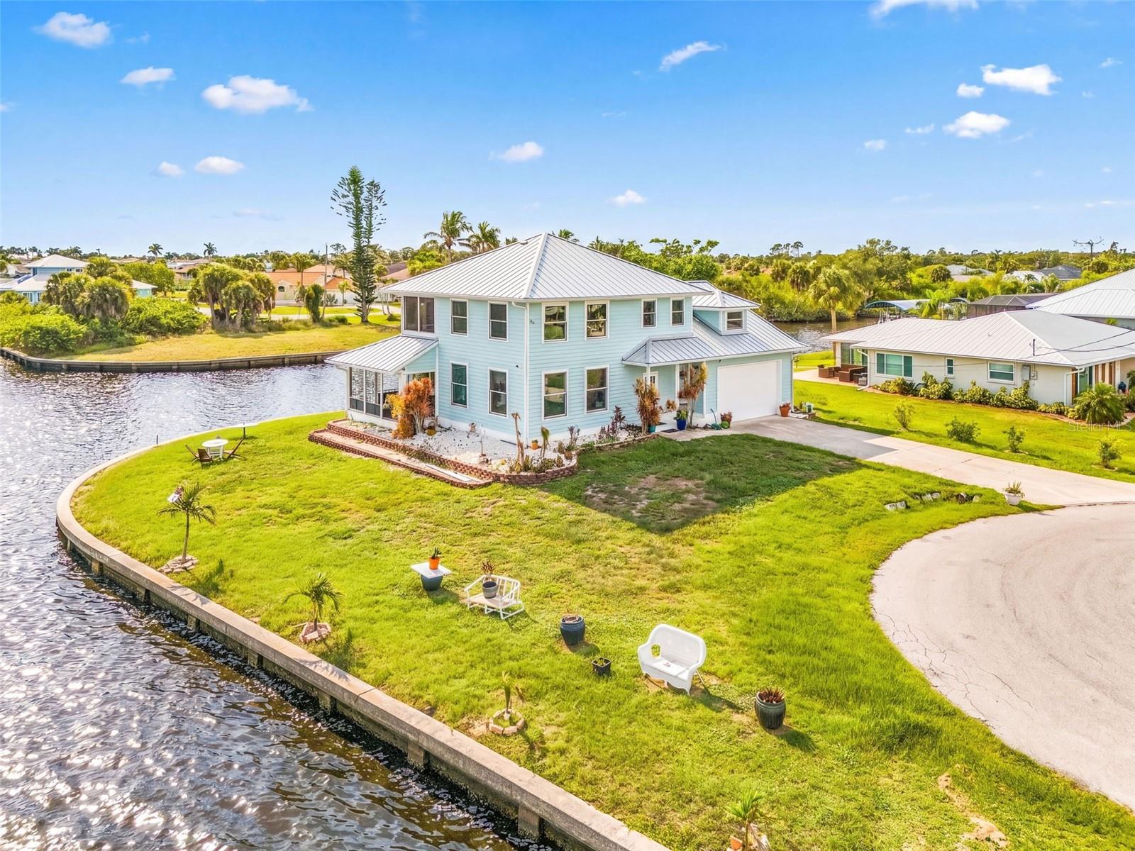 Front and river-side view of the home with seawall