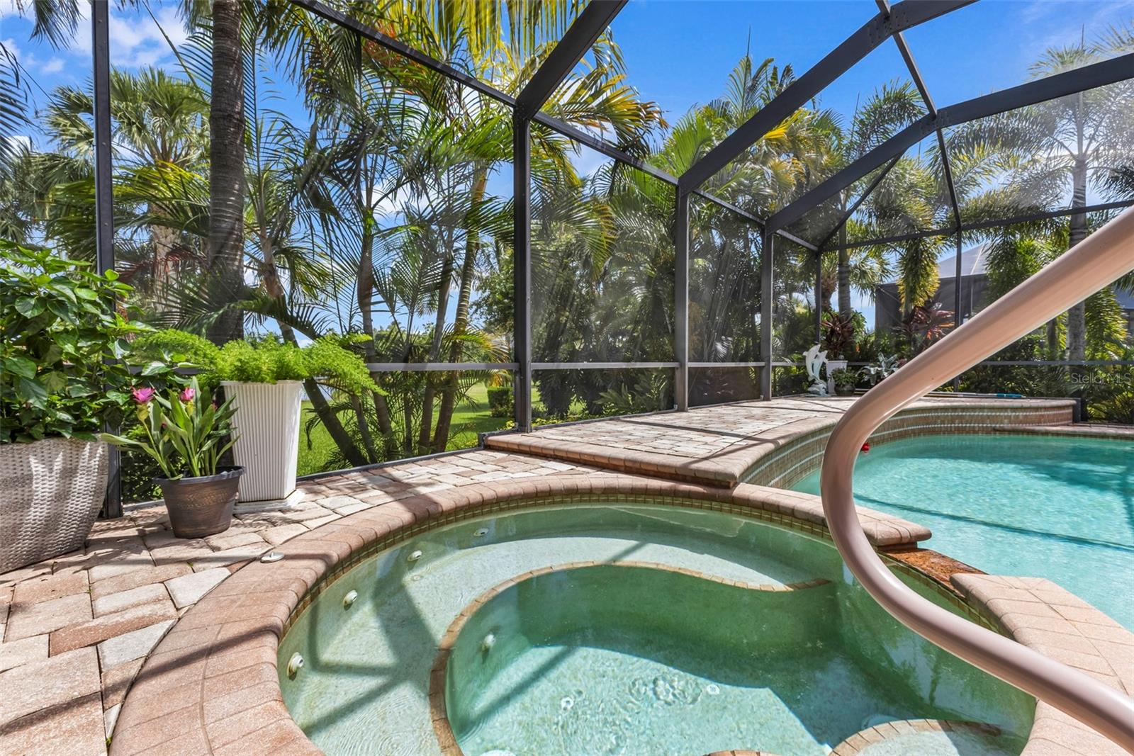 A private tropical retreat with a heated spa, sparkling pool and lush landscaping