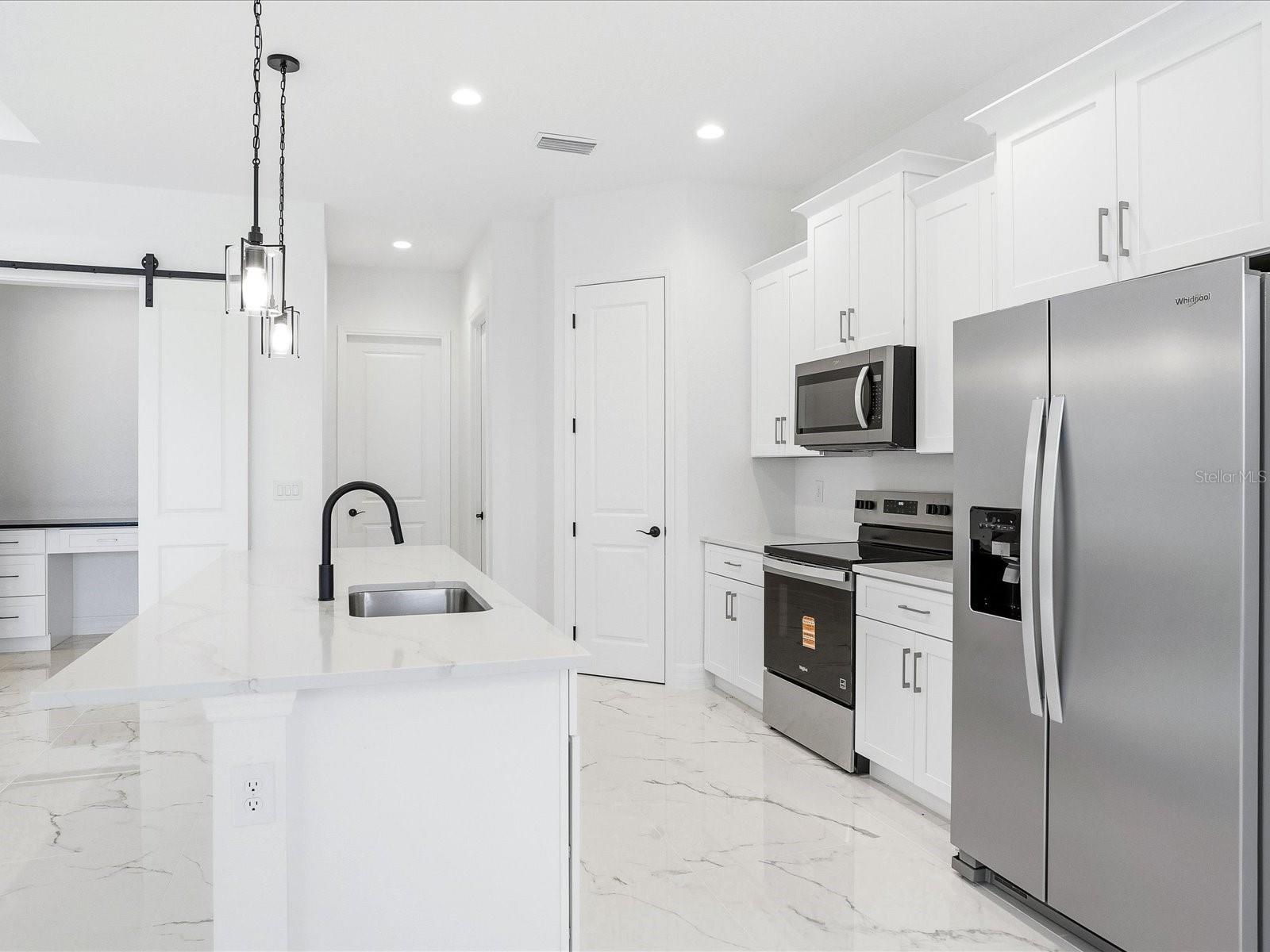 Kitchen has a walk-in corner pantry