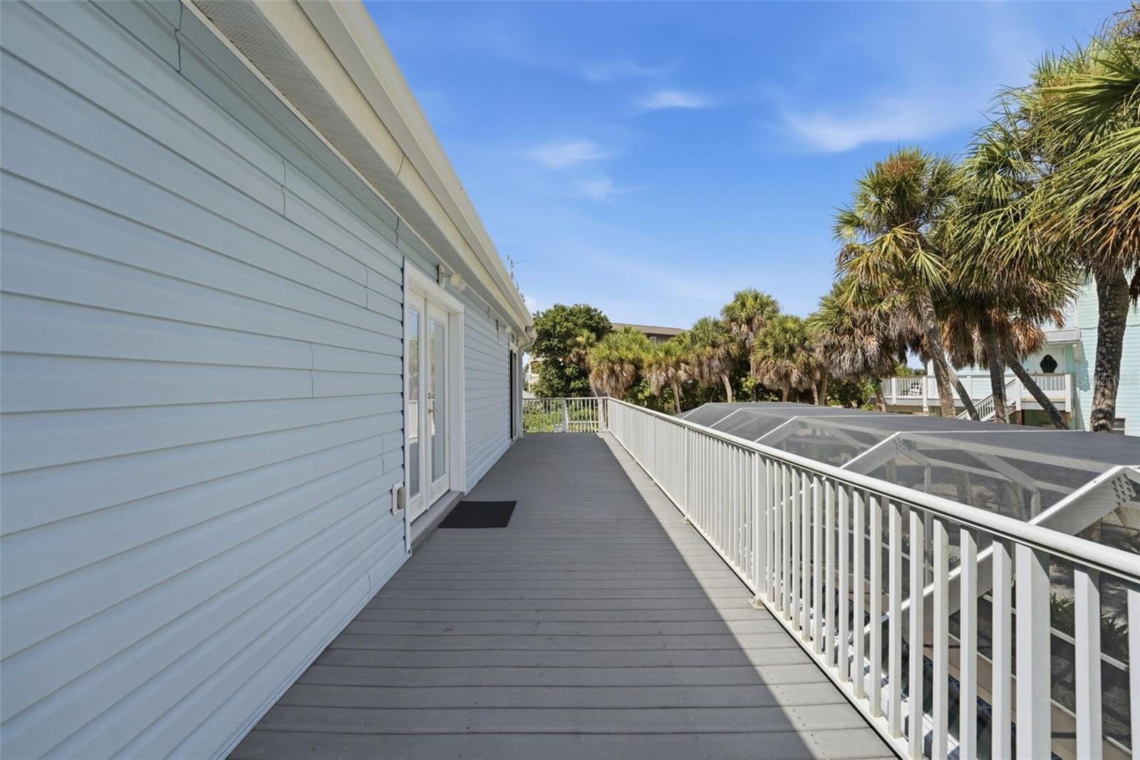 DECK OVERLOOKING CAGED POOL & FENCED YARD
