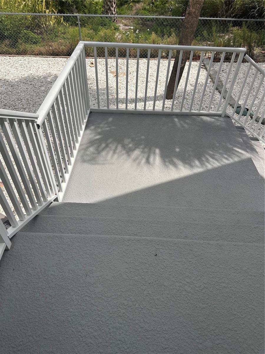 STEPS FROM DECK INTO FENCED YARD