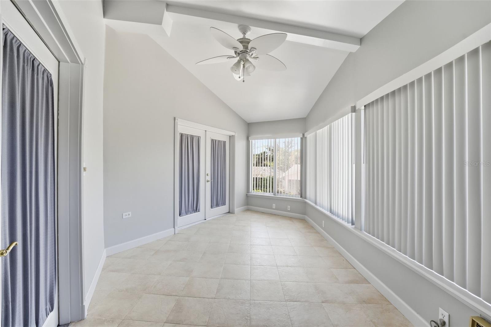 SUNPORCH OVERLOOKING CAGED POOL & FENCED YARD