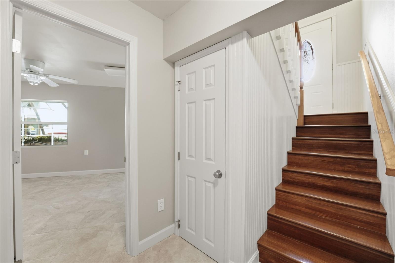 STAIRS FROM FRONT DOOR TO POOL LOUNGE AREA & GARAGE