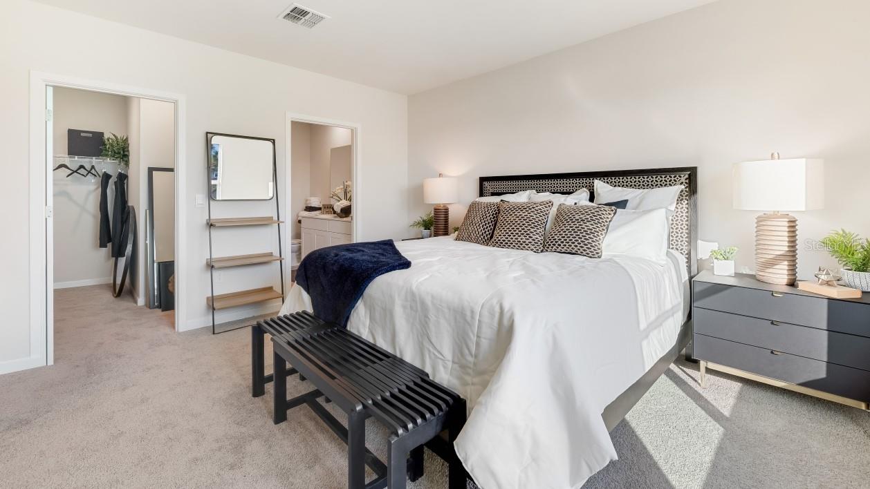 Inside of the primary bedroom. Contains walk in closet.