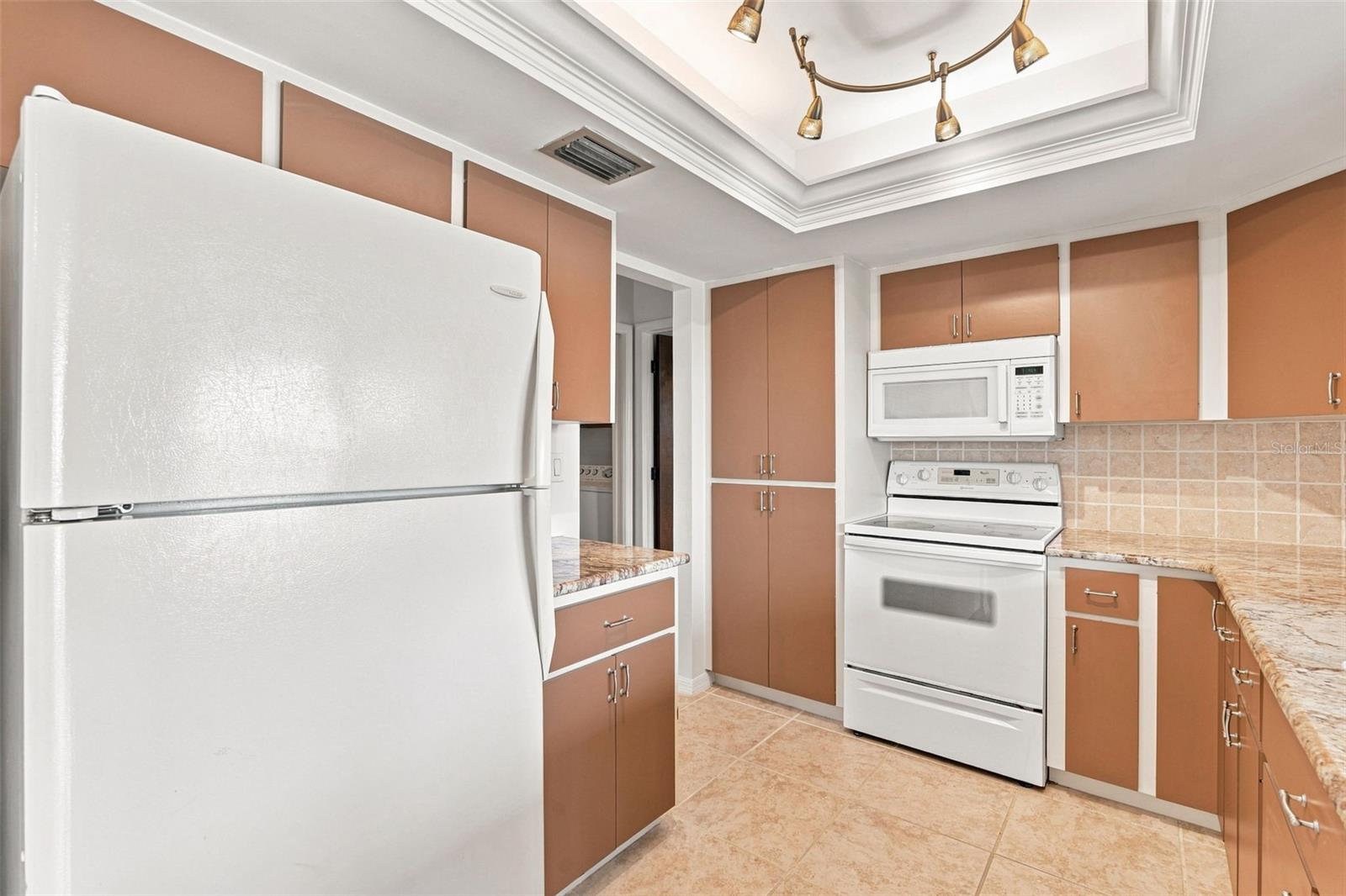 Kitchen Featuring Tray Ceiling, Crown Molding and Scenic Water Views