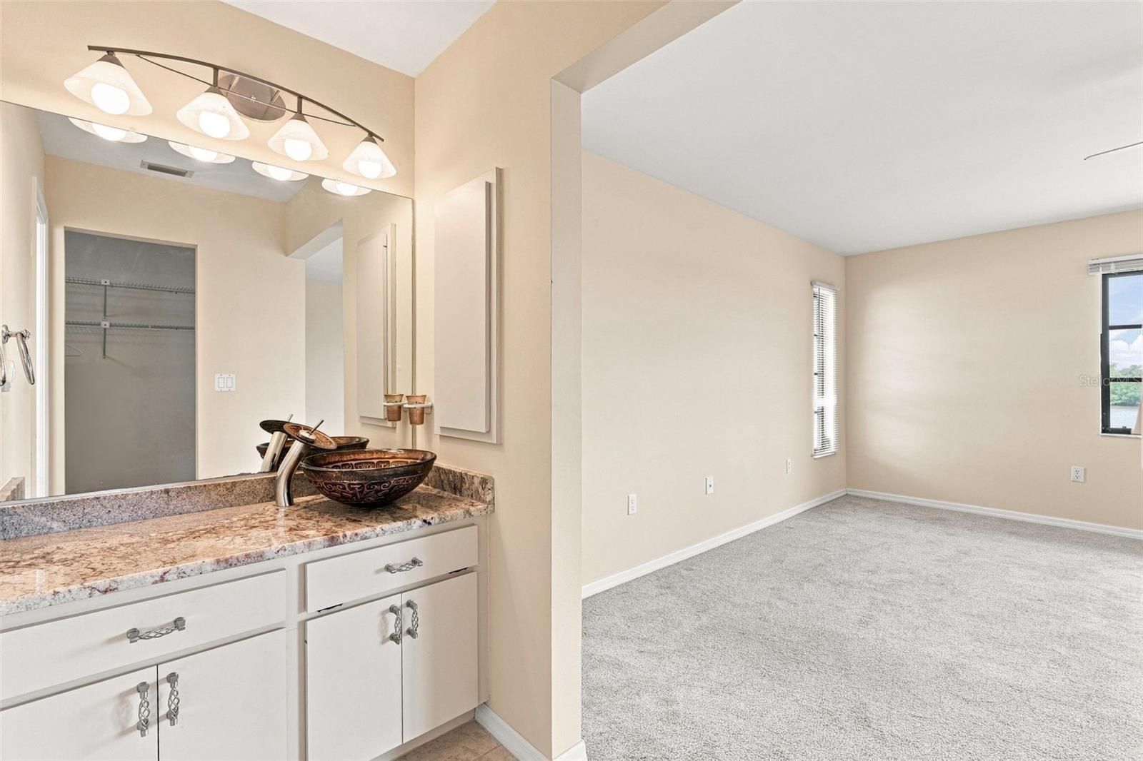 Ensuite Bathroom with Granite Vanity and Walk-in Closet
