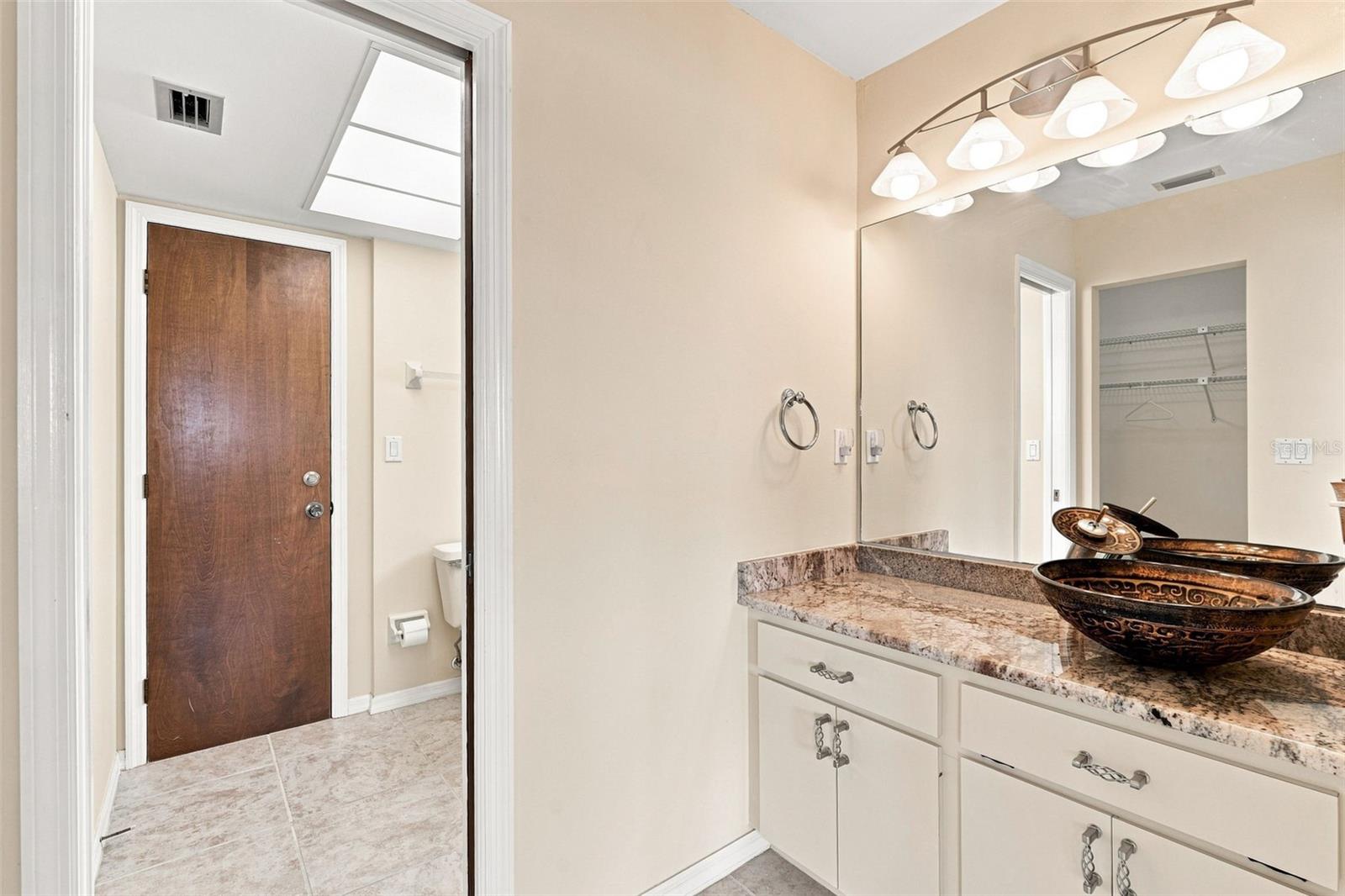 Ensuite Bathroom with Granite Vanity and Walk-in Closet