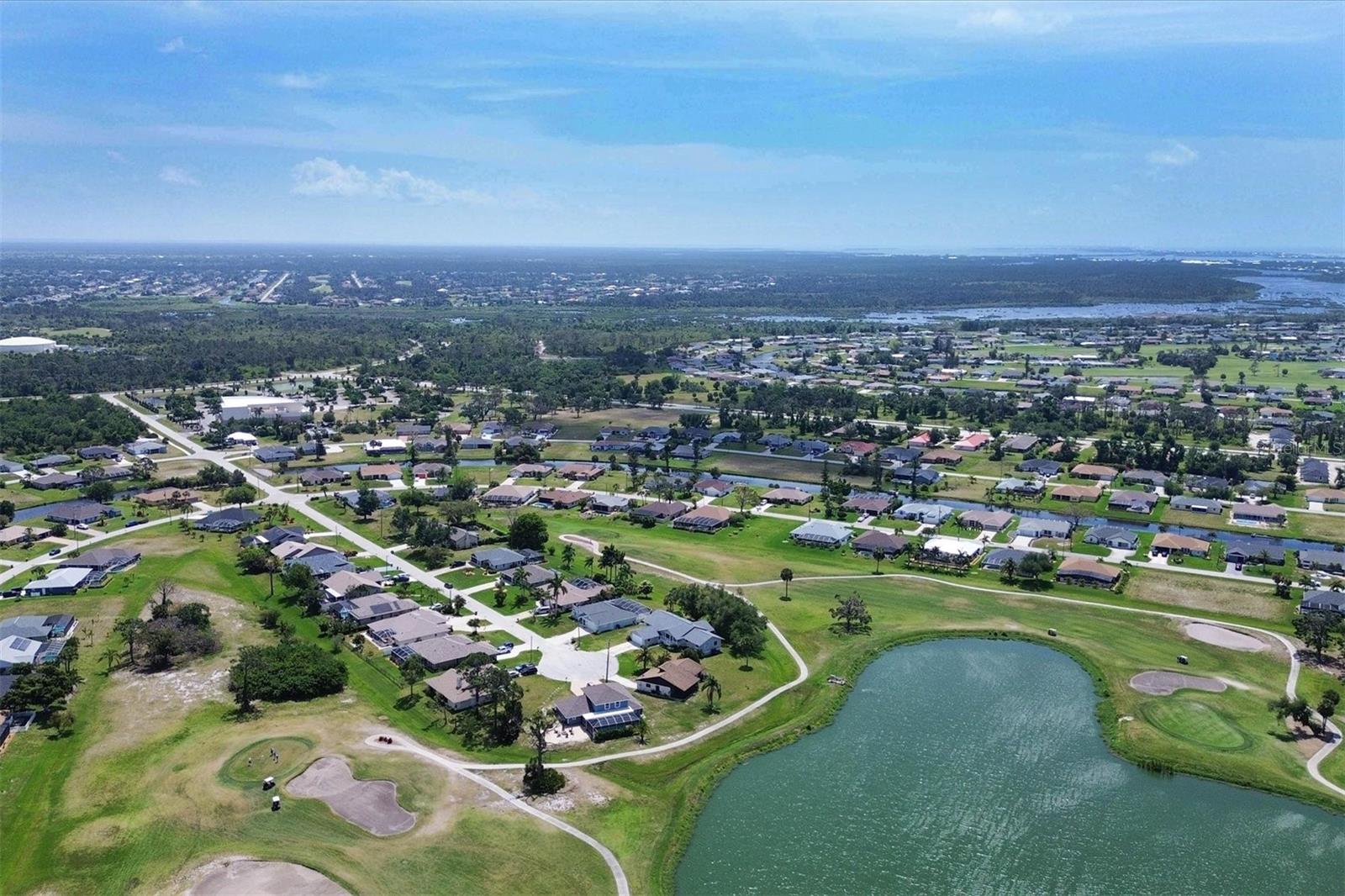 Wide pond and golf course view from above