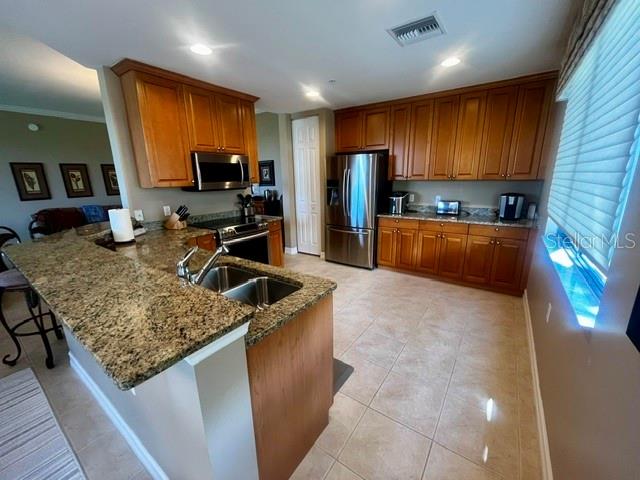 Kitchen features ample wood cabinets, granite countertops and SS appliances.