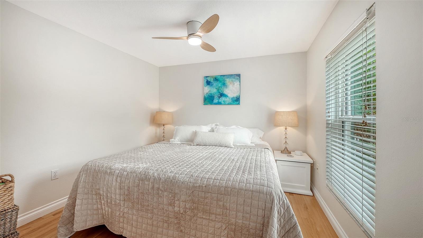 Comfortable bedroom 2 offers hardwood floors, generous natural light, and a tranquil, polished atmosphere.