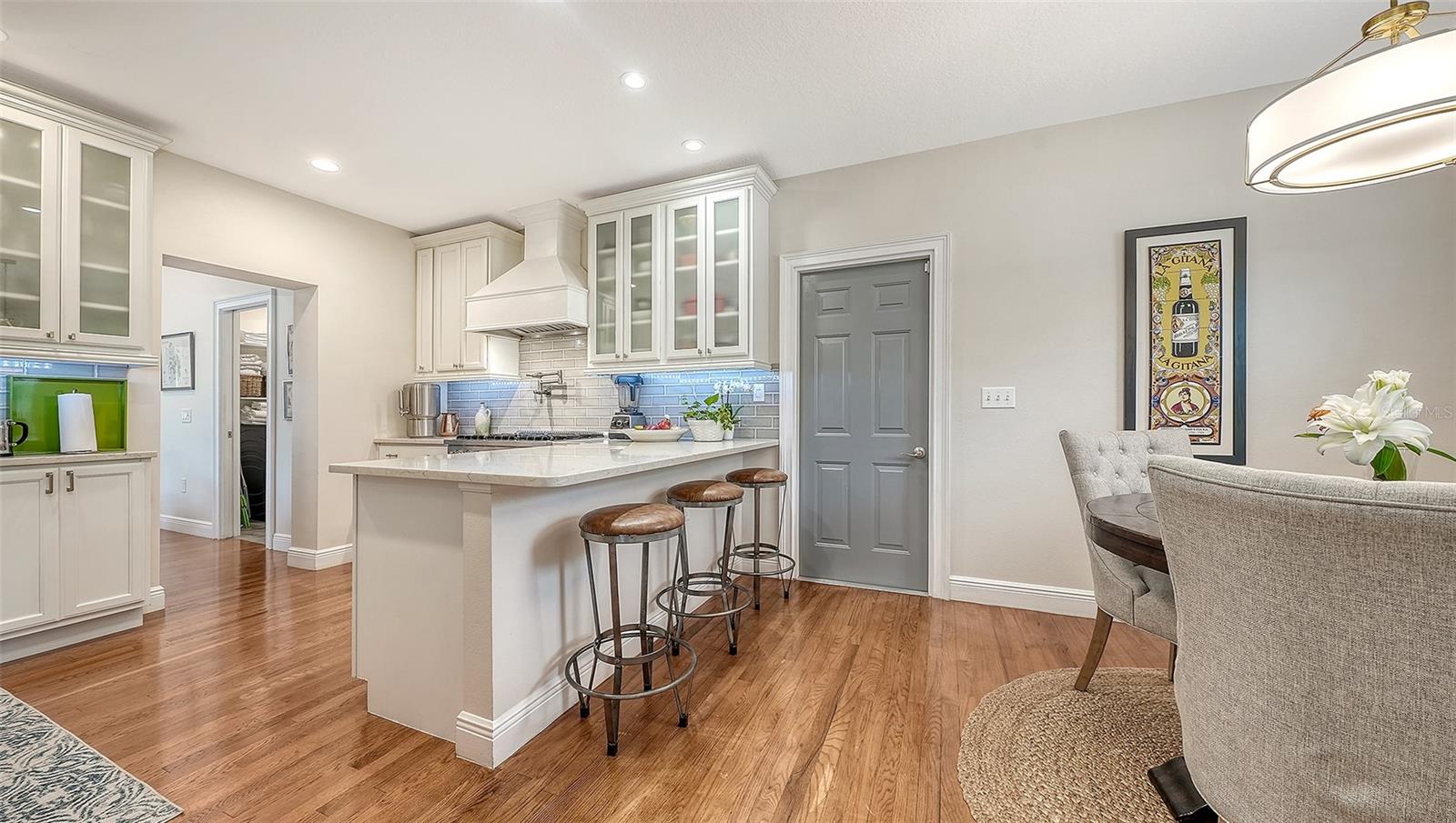 Chef’s kitchen features custom cabinetry, quartz countertops, premium stainless appliances, and a generous center island designed for effortless entertaining.