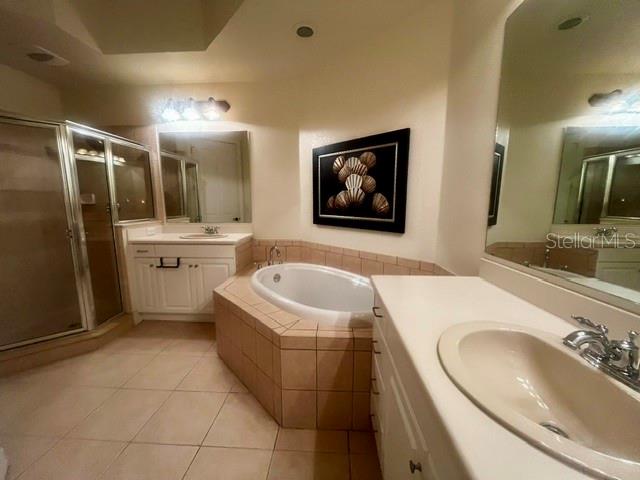 Primary en-suite bath features double vanities, garden tub and separate shower.