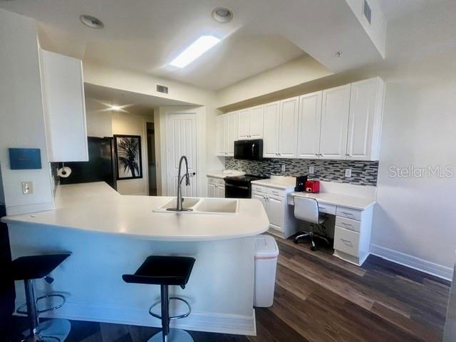 Stunning kitchen with ample cabinet space, breakfast bar, and decorative glass backsplash. New appliances with transferrable warranty until January 2029.