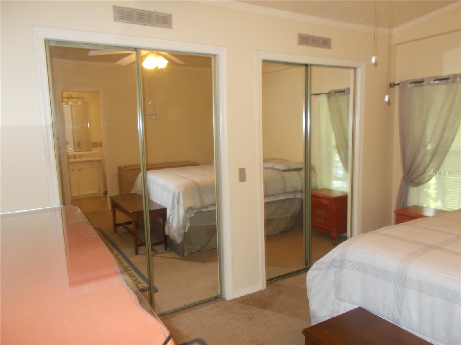 Primary Bedroom showing 2 mirrored closets