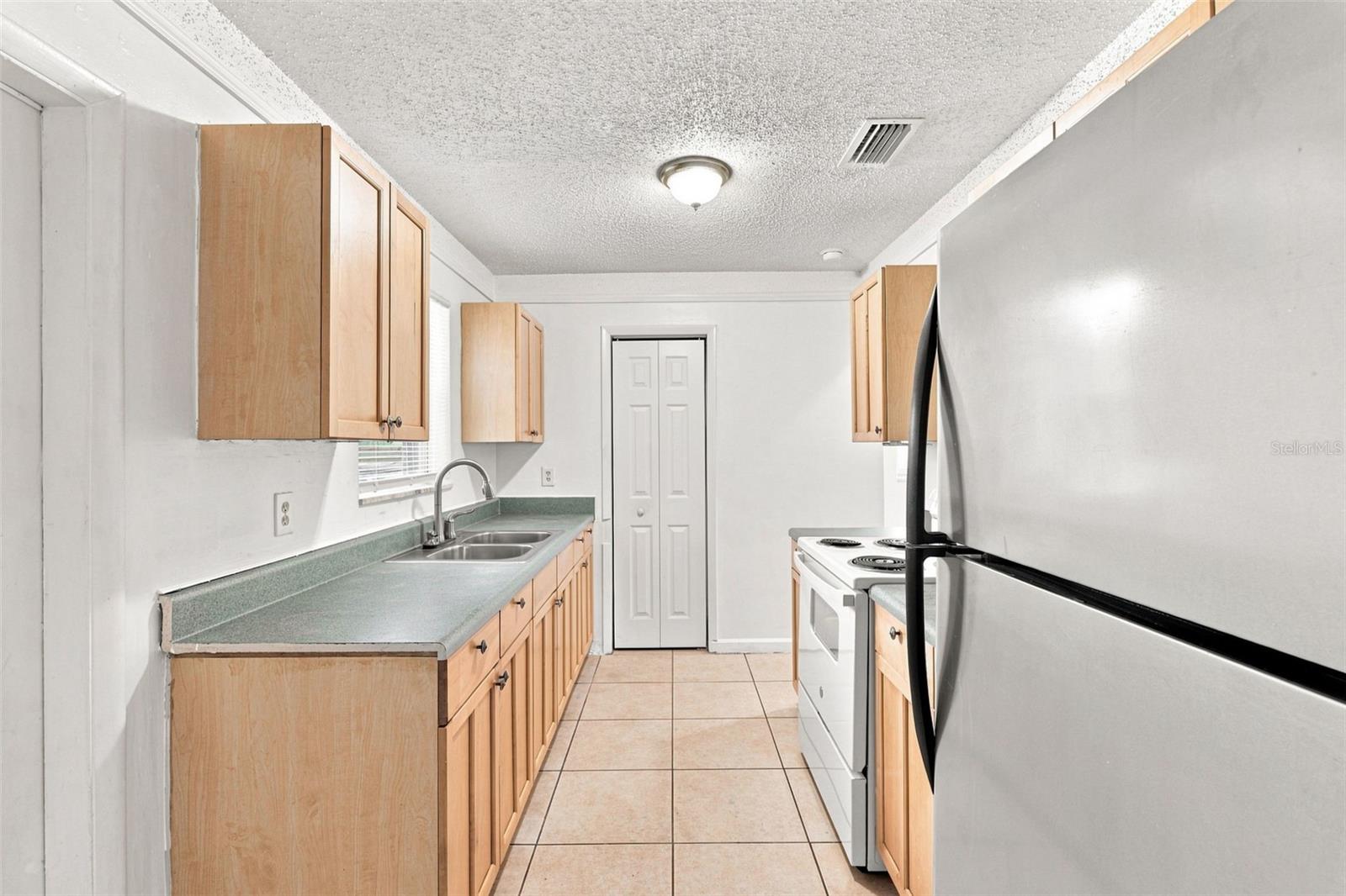 Bright Kitchen with Abundant Cabinetry & Counter Space