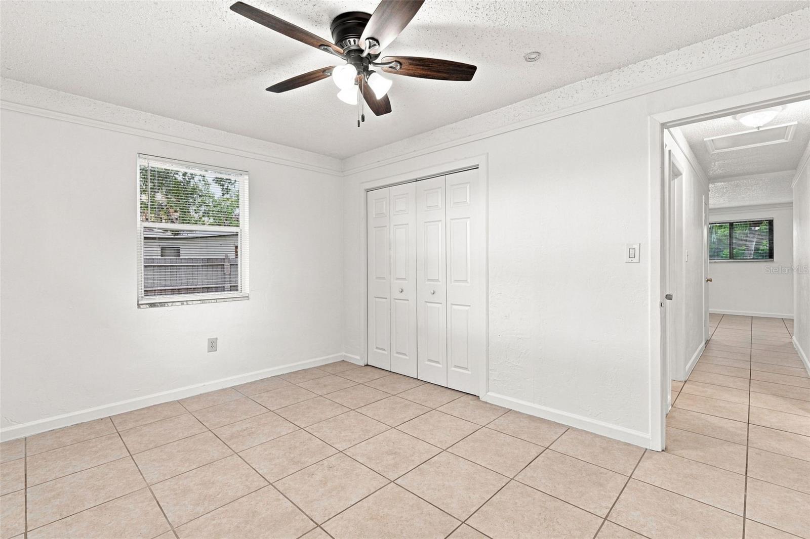 Second Bedroom with Tile Floor and Ceiling Fan