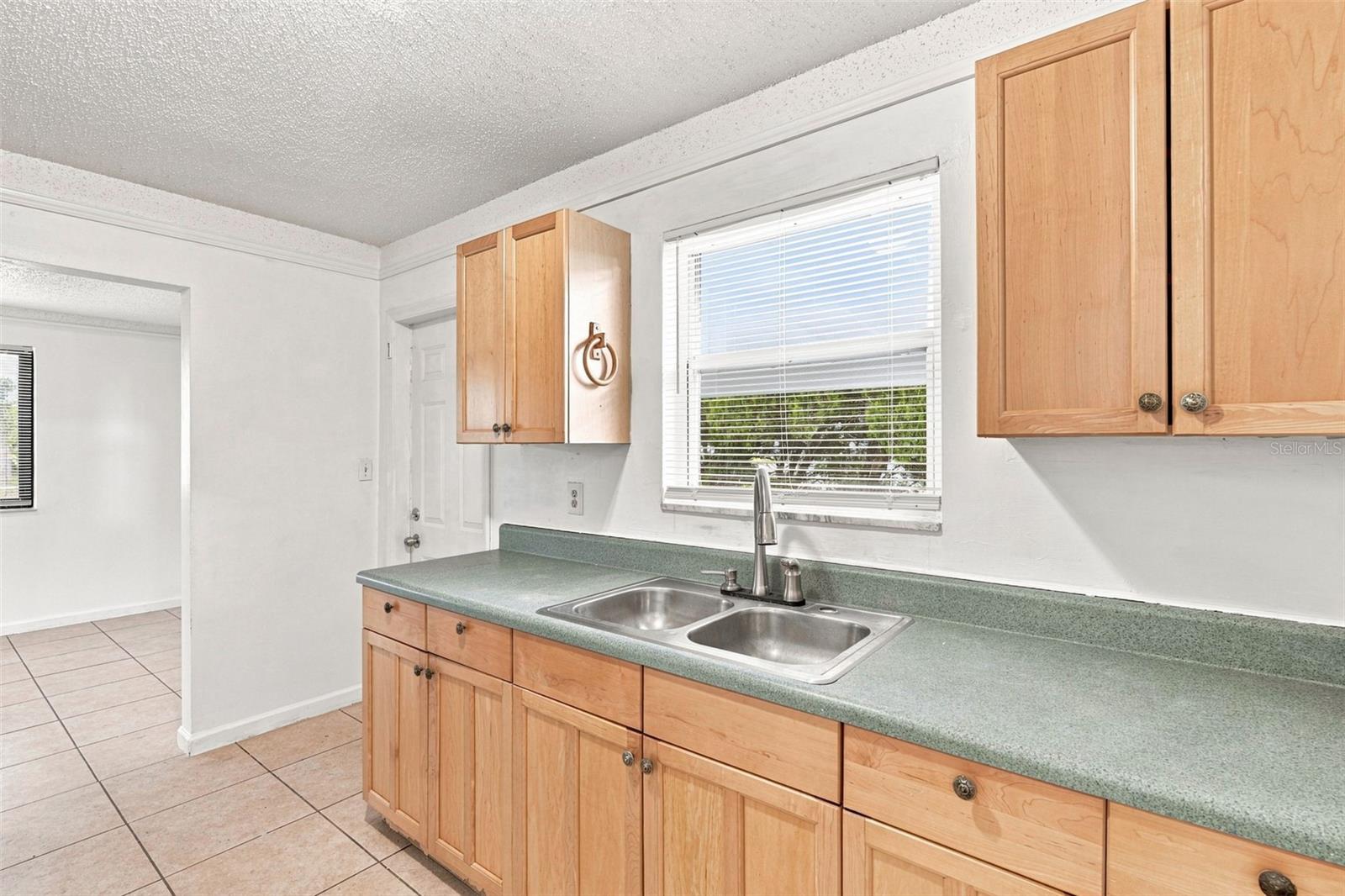 Wide Galley Kitchen with Double Basin Sink and Window View