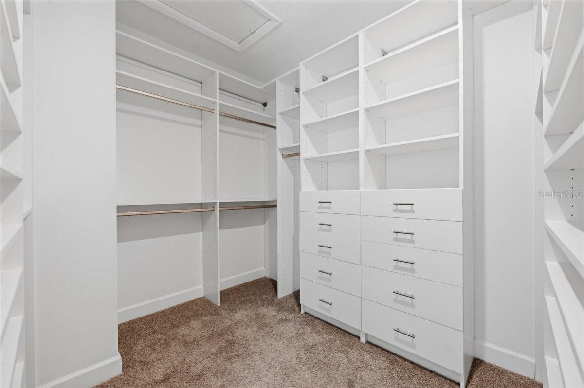 Primary bedroom closet with built in's