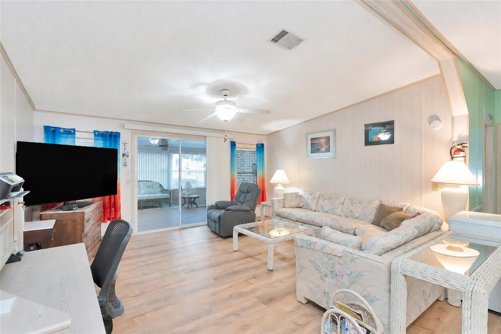 Very spacious, open living room w/sliding doors into the enclosed sunroom