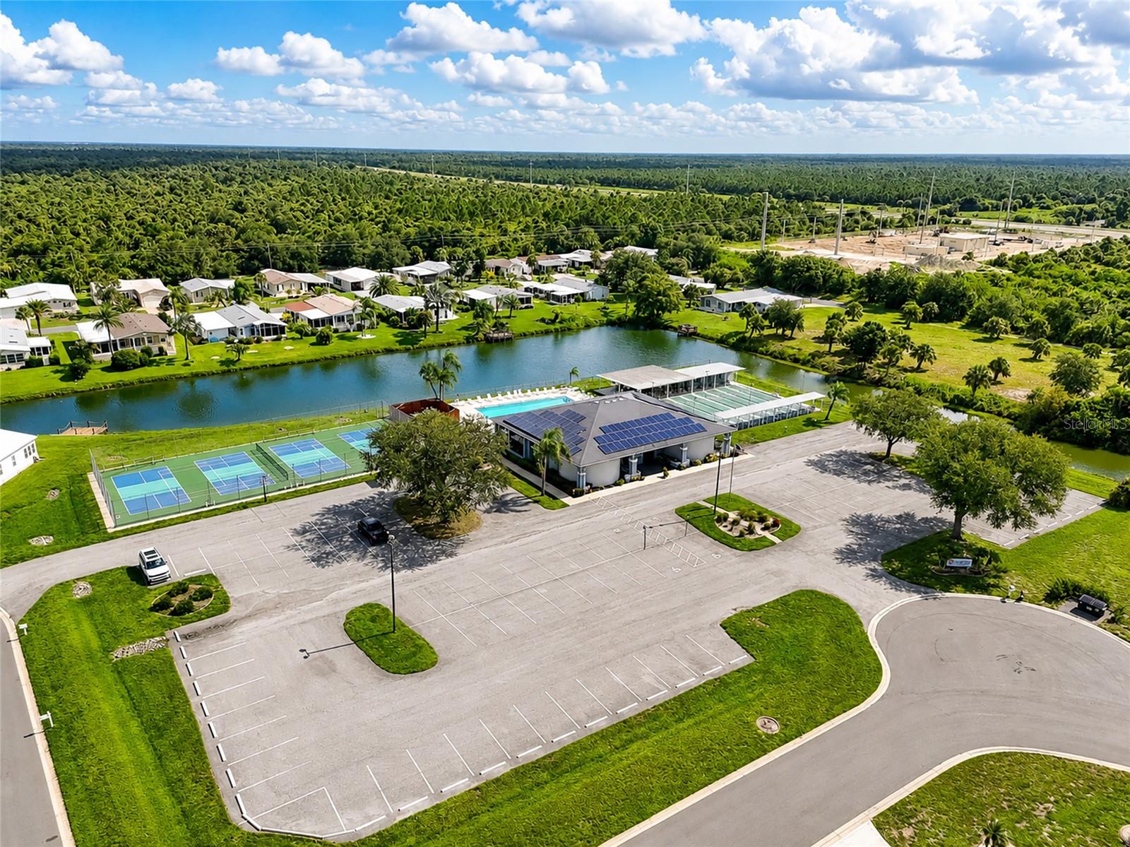Aerial view of Clubhouse, tennis courts (can be used for pickleball), swimming pool and bocce ball