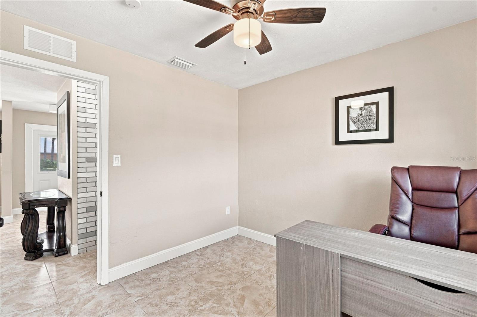 Second Bedroom with Large Window, Ceiling Fan, & Tile Floor