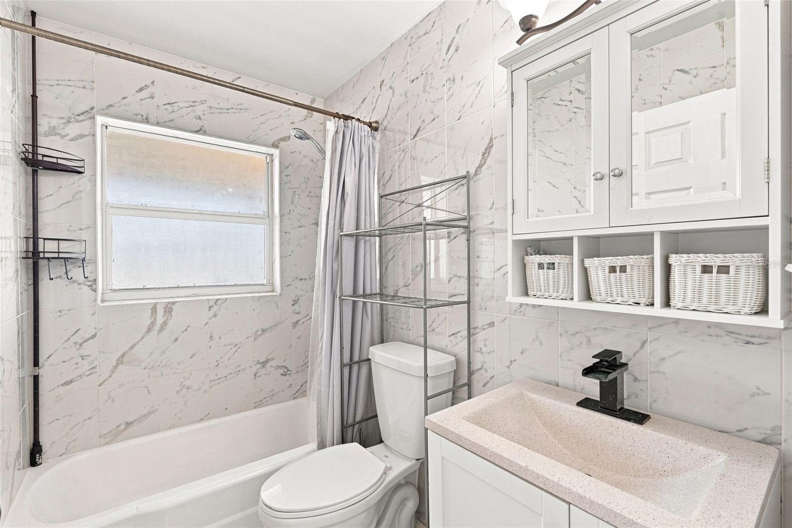 Full Bathroom with Updated Vanity and Tile Surround