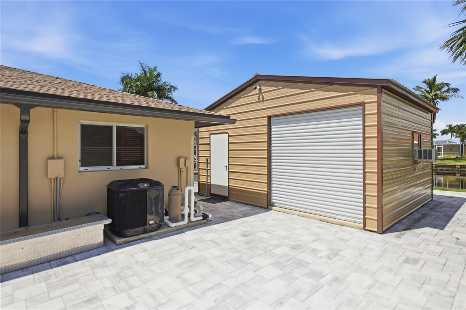 Extra pavers on right side of home, nice workshop with window a/c