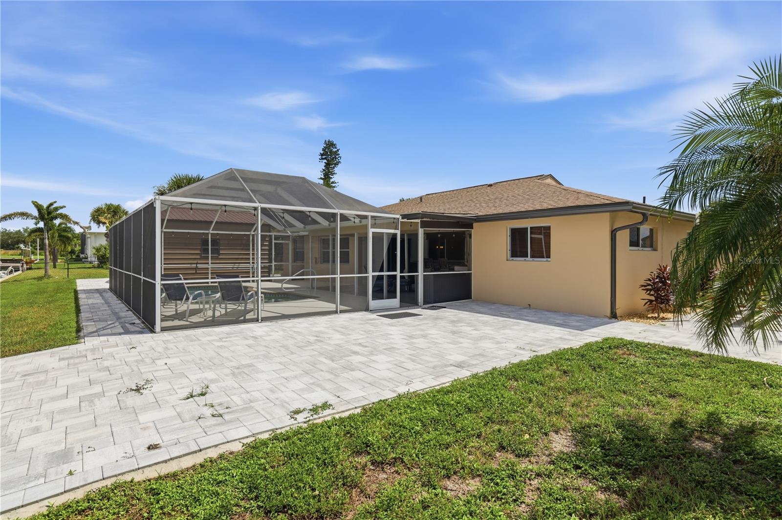 Pavers on back side of home, room for a hot tub there, outside sunning chairs, fire pit.