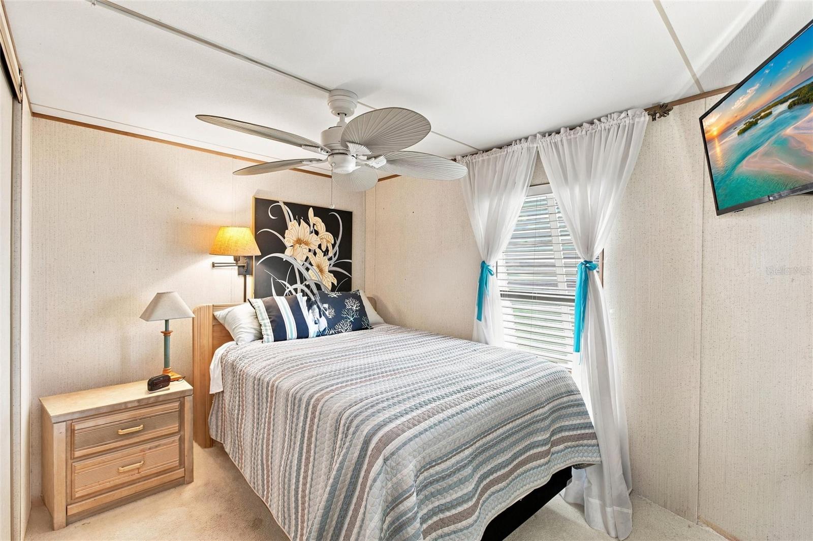 Bedroom with full size bed and ceiling fan
